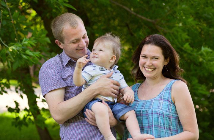 Parents outside holding their baby