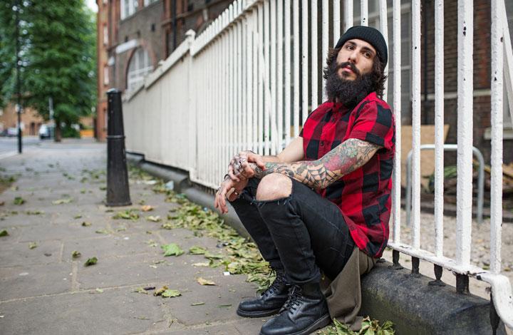 Man sitting on side of the street