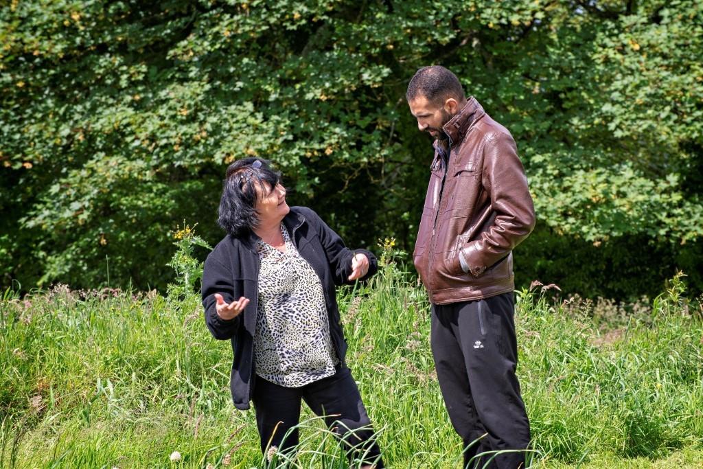 Photo of two people outside as part of the Refugee Health Policy and Action Group programme