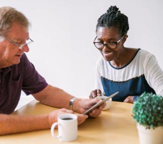 Older man and woman using technology