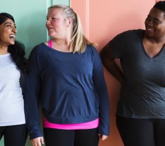 Three women smiling and laughing