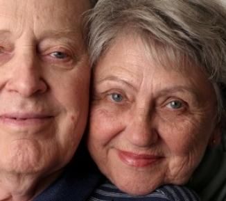 Elderly couple smiling at the camera