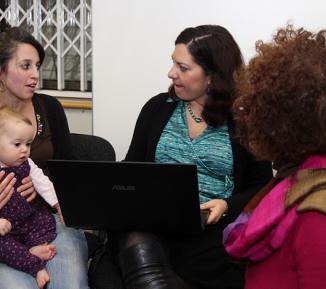 Photo of a group of women discussing motherhood