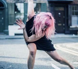 Woman dancing in the street - positive image library