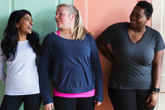 Three women smiling and laughing