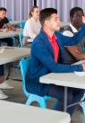 Man putting his hand up to ask a question in a room