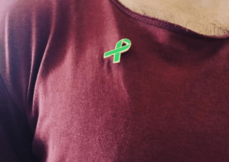 Person wearing green ribbon badge