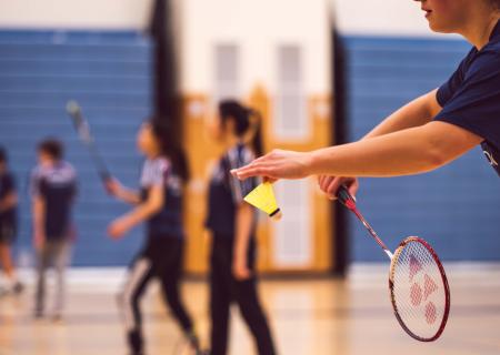 Young people playing badminton