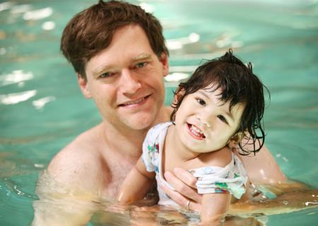 Father and baby girl in swimming pool