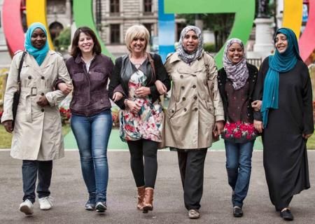 Women smiling in a line