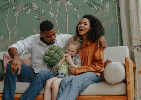 Mother and father smiling and laughing with their child