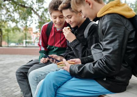 Young boys eating lunch outside