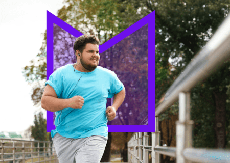 A young man running across a bridge while he listens to music 